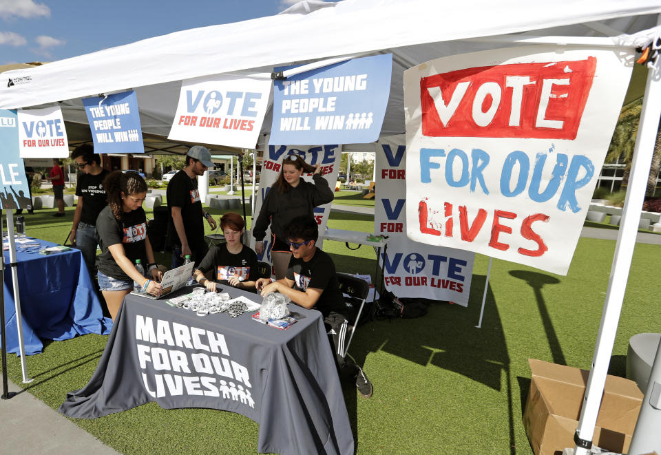 In this Wednesday, Oct. 31, 2018 photo, student volunteers help out at a booth to encourage on campus voting for students during a Vote for Our Lives event at the University of Central Florida in Orlando, Fla. Nine months after 17 classmates and teachers were gunned down at their Florida school, Parkland students are finally facing the moment they’ve been leading up to with marches, school walkouts and voter-registration events throughout the country: their first Election Day. (AP Photo/John Raoux)