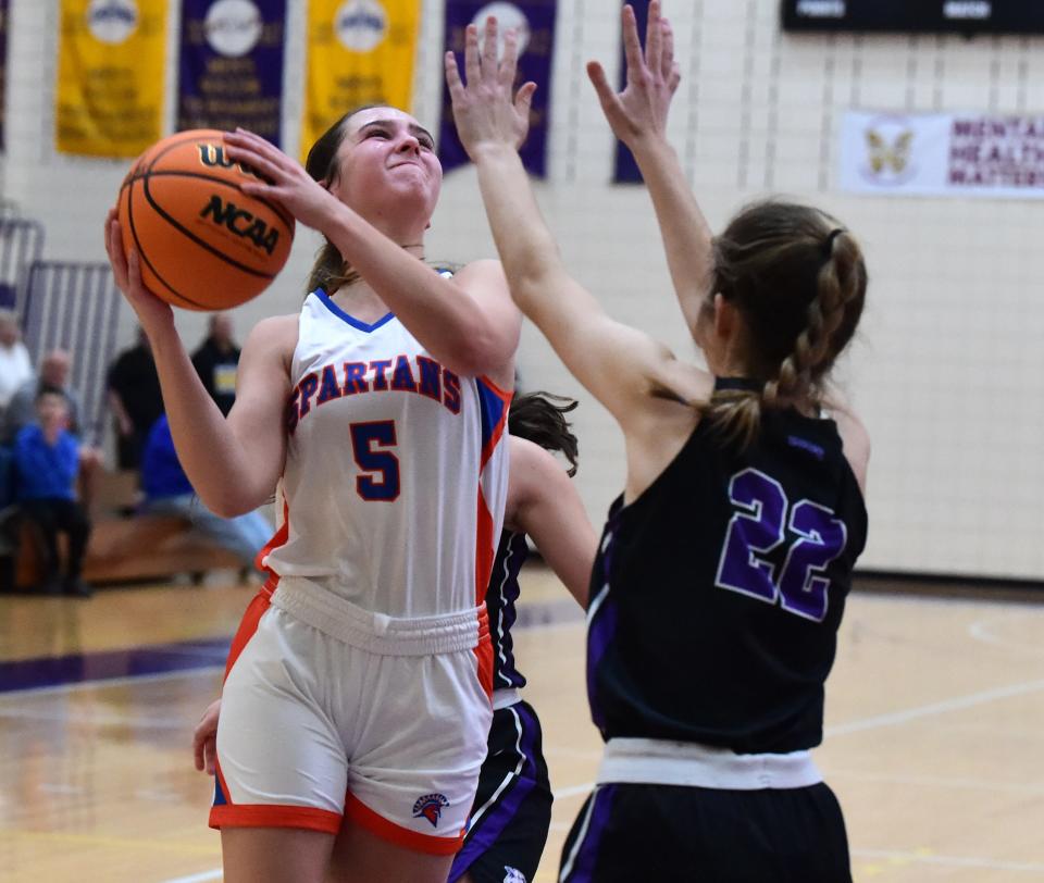 Thomas A. Edison's Payton Littlefield goes up for a shot as Union Springs' Ainsley Francis-Biter defends during the Spartans' 60-57 win in girls basketball Dec. 9, 2023 at Elmira College's Speidel Gymnasium.