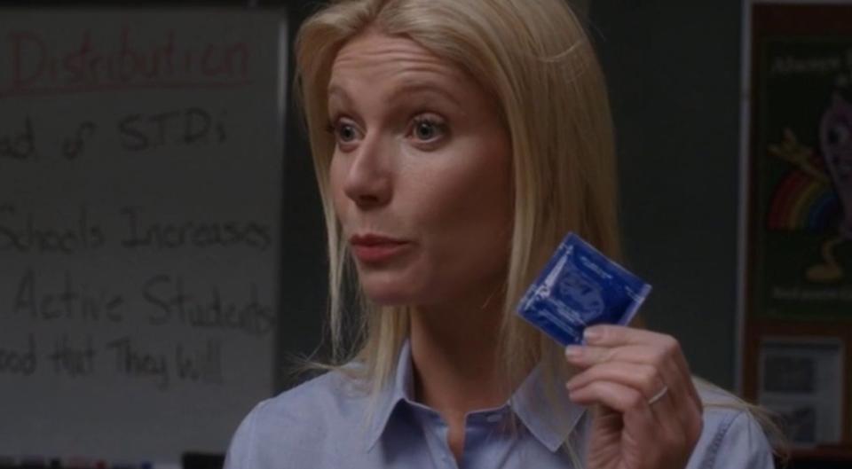 Ms. Holiday holding up a condom for demonstration