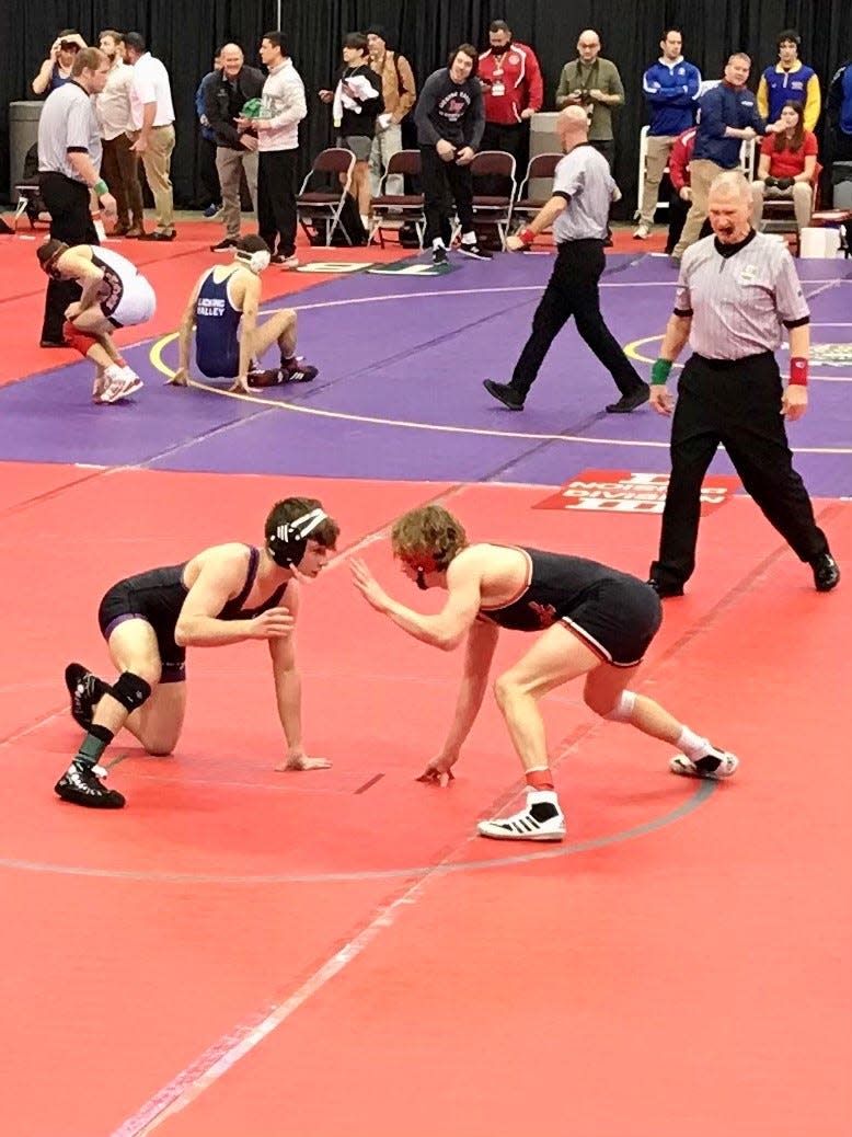 Pleasant's Daxton Chase, right, competes at last year's Division III state wrestling tournament at Ohio State's Schottenstein Center. Chase recently earned his 100th career victory.