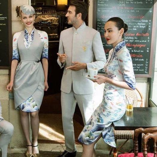 Men’s version of the uniform is a bit less extravagant and Western-looking, with double-breasted overcoats and smaller elements of the traditional Chinese culture. Photo: Hainan Airlines