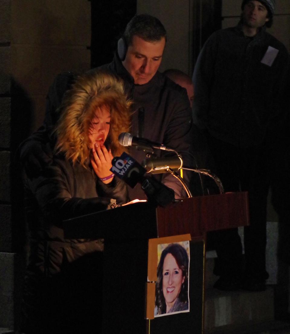 Bethany Medeiros of Middleboro reads a letter she wrote to her mother Lori Ann Medeiros at a candlelight vigil at Middleboro Town Hall on Sunday, Nov. 20, 2022. To the right is her father Paul Medeiros. Lori Ann Medeiros was killed in a car crash on Nov. 7, 2022, in Taunton when a man allegedly fleeing police slammed into her vehicle.