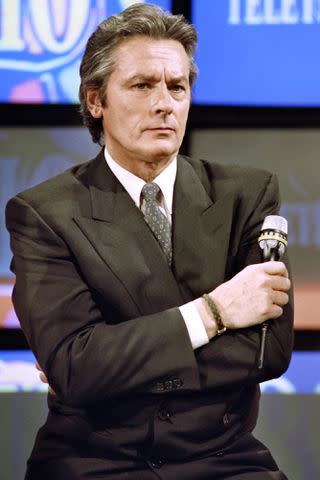 <p>JEAN-PIERRE MULLER/AFP via Getty</p> Alain Delon in 1990.