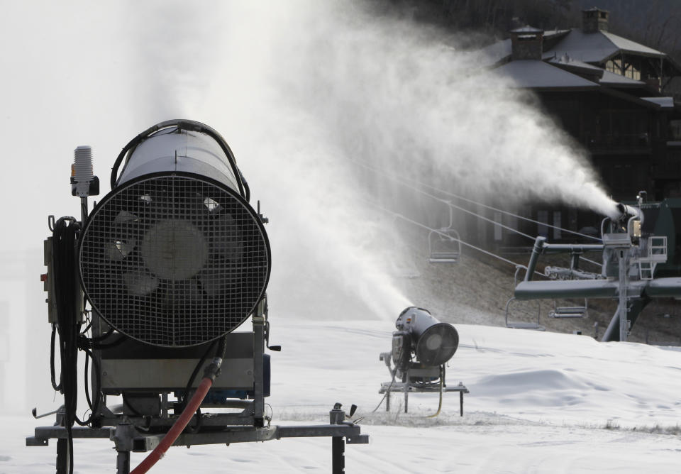 This Nov. 15, 2012 photo shows snow guns making fresh snow at the Stowe resort in Stowe, Vt. The ground might be bare, but ski areas across the Northeast are making big investments in high-efficiency snowmaking so they can open more terrain earlier and longer. (AP Photo/Toby Talbot)