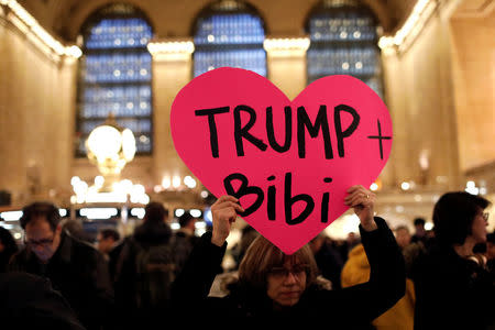A demonstrator holds a sign during a "Muslim and Jewish Solidarity" protest against the policies of U.S. President Donald Trump and Israeli Prime Minister Benjamin Netanyahu at Grand Central Terminal in New York City, U.S., February 15, 2017. REUTERS/Mike Segar
