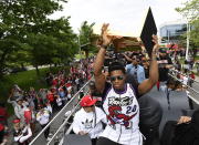 Toronto Raptors guard Kyle Lowry hoists the Larry O'Brien Championship Trophy during the 2019 Toronto Raptors NBA basketball championship parade in Toronto, Monday, June 17, 2019. (Photo by Frank Gunn/The Canadian Press via AP)