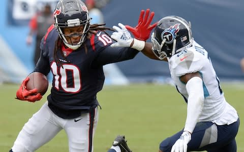 Houston Texans wide receiver DeAndre Hopkins (10) tries to get past Tennessee Titans defensive back Malcolm Butler (21) in the first half of an NFL football game - Credit: AP Photo/Mark Zaleski