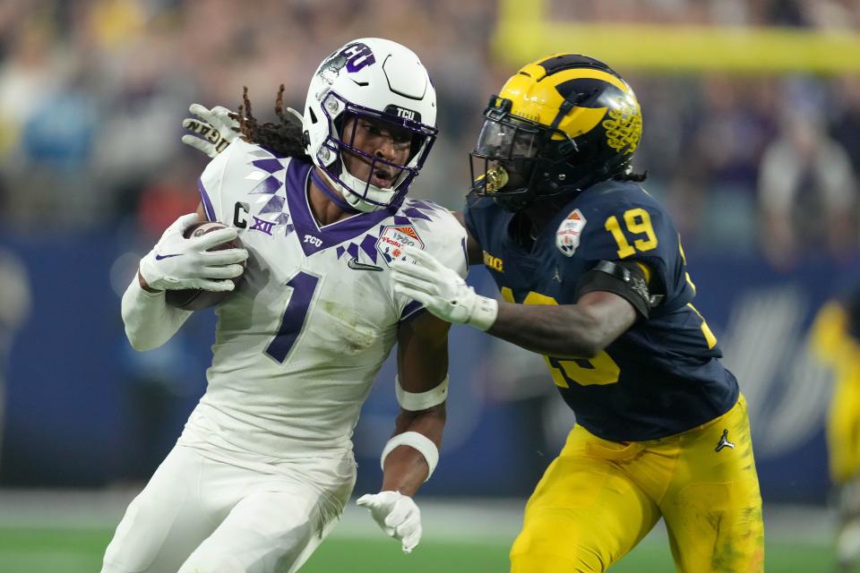 Dec 31, 2022; Glendale, Arizona, USA; TCU Horned Frogs wide receiver Quentin Johnston (1) is defended by Michigan Wolverines defensive back Rod Moore (19) in the second half of the 2022 Fiesta Bowl at State Farm Stadium. Mandatory Credit: Kirby Lee-USA TODAY Sports