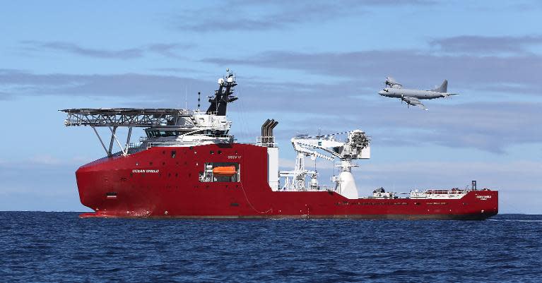 A Royal Australian Air Force plane flies past the Australian Defence Vessel Ocean Shield on a mission to drop sonar buoys to assist in the acoustic search for missing Malaysia Airlines flight MH370 in the southern Indian Ocean, April 9, 2014