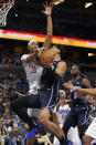 Orlando Magic forward Paolo Banchero drives to the basket under pressure from Los Angeles Clippers guard Luke Kennard during the first half of an NBA basketball game Wednesday, Dec. 7, 2022, in Orlando, Fla. (AP Photo/Scott Audette)