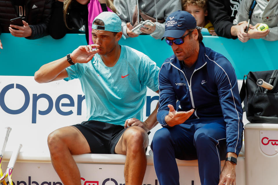 Coach Carlos Moya (pictured right) talking with Rafa Nadal (pictured left).