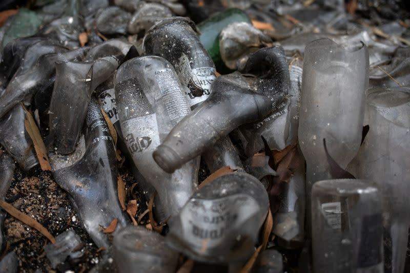 Bottles that melted due to a bushfire are see on the ground in the village of Mogo