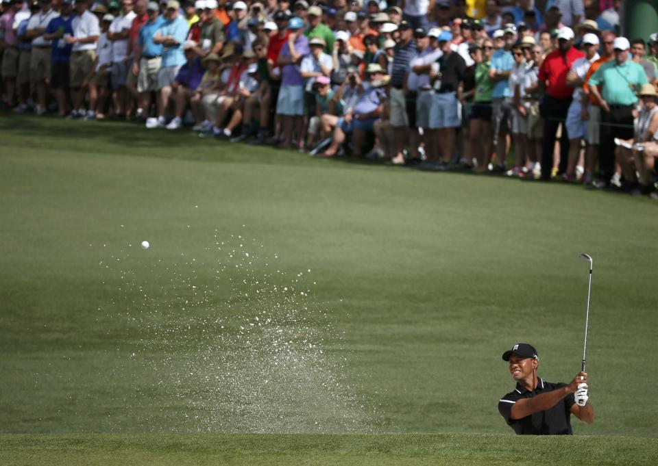 Tiger Woods of the U.S. hits from a sand trap onto the second green during second round play of the Masters golf tournament at the Augusta National Golf Course in Augusta, Georgia April 10, 2015. REUTERS/Phil Noble