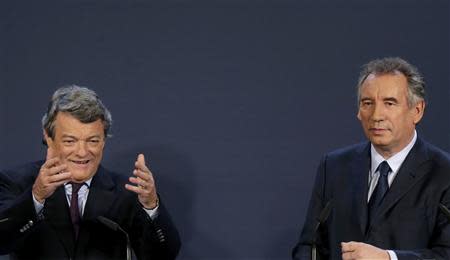 Jean-Louis Borloo (L), head of the Union Democratic Independant (UDI) political party, and Francois Bayrou, centrist MoDem political party leader, attend a news conference to announce the union of their centrist parties in Paris, November 5, 2013. REUTERS/Jacky Naegelen