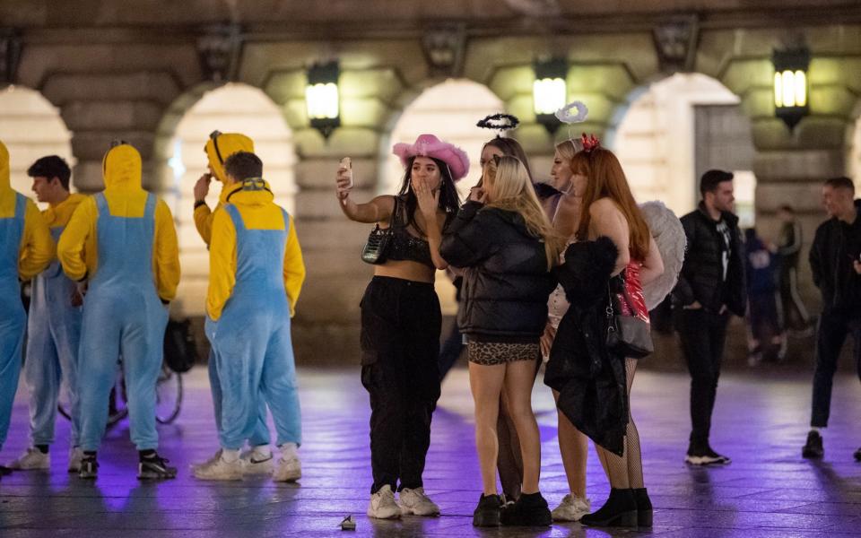 People in fancy dress in Nottingham after pubs and bars close - PA