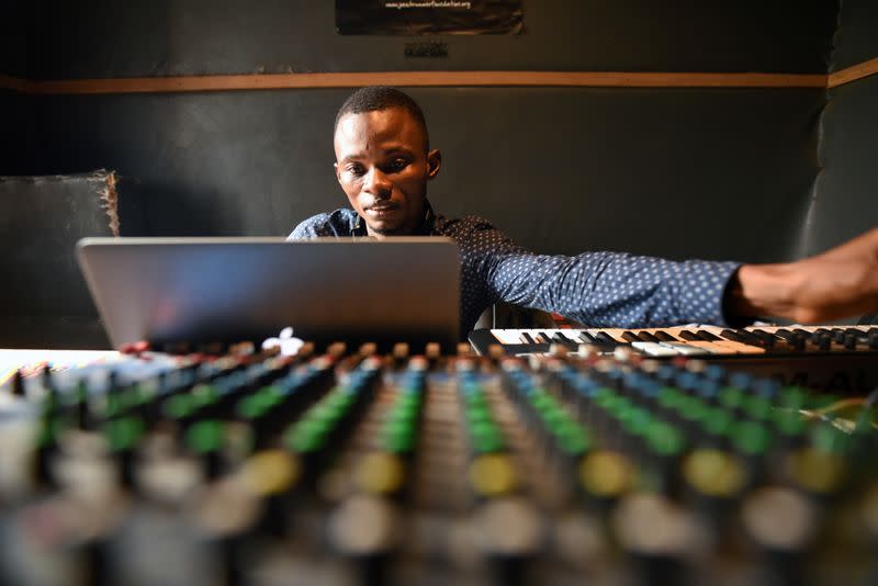 Gibrilla Kamara, Way Out's office manager, mixes tracks in the media center's recording studio in Freetown