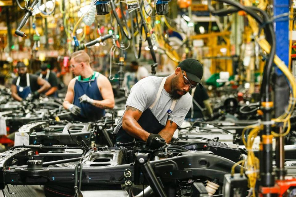 General Motors employees work on the assembly line at GM’s Arlington Assembly plant in 2019. The plant was not targeted in a strike that began Friday by UAW workers.