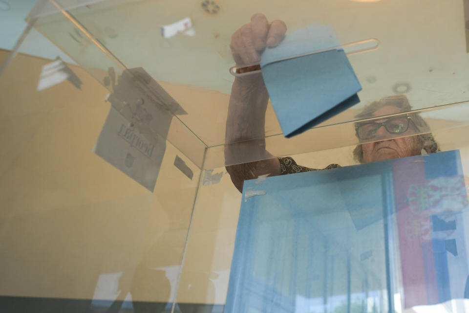 A voter casts her ballot for the local election at a polling station in Belgrade, Serbia, Sunday, June 2, 2024. Voters in Serbia on Sunday are casting ballots in a rerun election in the capital, Belgrade, and in dozens of other cities and towns, with ruling right-wing populists seeking to cement their already vast hold on power. The vote in Belgrade is being repeated after reports of widespread irregularities last December triggered political tensions and accusations that President Aleksandar Vucic's Serbian Progressive Party rigged the vote. (AP Photo/Darko Vojinovic)