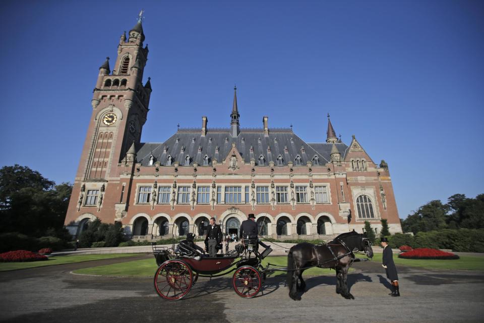 FILE - In this Aug. 28, 2013 file photo, a horse-drawn carriage stands in front of the Peace Palace, seat of the International Court of Justice (ICJ) in The Hague, Netherlands, Wednesday, Aug. 28, 2013. The tiny Pacific nation of the Marshall Islands that was used for dozens of U.S. nuclear tests after World War II is taking on the United States and the world’s eight other nuclear-armed nations with an unprecedented lawsuit demanding that they meet their obligations toward disarmament and accusing them of 'flagrant violations' of international law. The suit was filed on Thursday, April 24, 2014 at the ICJ. (AP Photo/Peter Dejong, File)