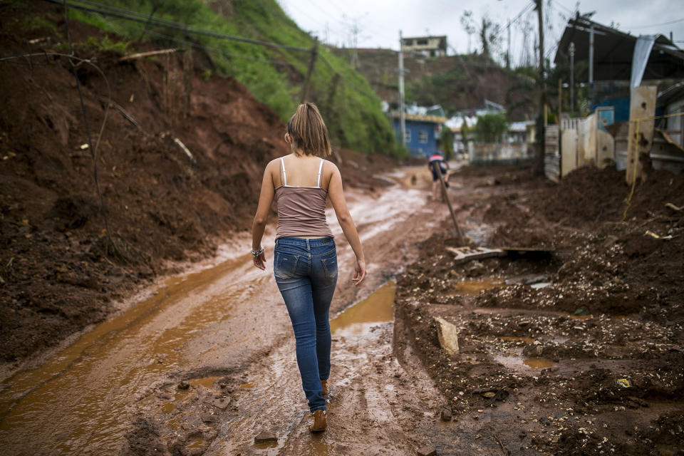 <p>A resident walks along a muddy road in Barranquitas, Puerto Rico, on Wednesday, Oct. 18, 2017. (Photo: Xavier Garcia/Bloomberg via Getty Images) </p>