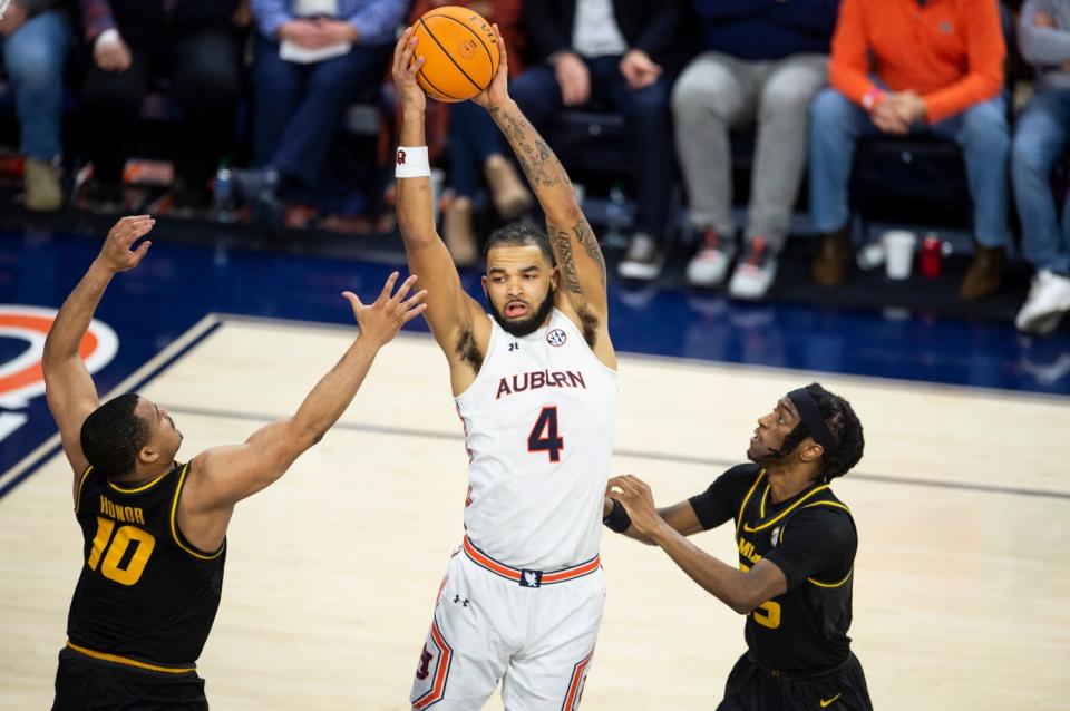 Auburn Tigers forward Johnny Broome (4) grabs a rebound as the Auburn Tigers take on the Missouri Tigers at Neville Arena in Auburn, Ala., on Tuesday, Feb.  14, 2023. Auburn Tigers defeated Missouri Tigers 89-56.