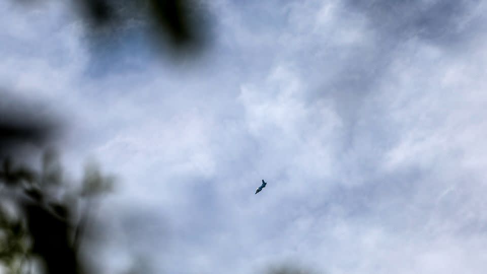 A Myanmar military jet flies overhead after bombing the quarters of Karenni Nationalities Defence Force (KNDF), in Kayah state, Myanmar on July 6, 2022. - Kaung Zaw Hein/SOPA Images/LightRocket/Getty Images