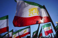 <p>Iranian flag flutter in the wind as the Organization of the Iranian American Communities holds a demonstration in Lafayette Park across for the White House in Washington, Saturday, Jan. 6, 2018, in solidarity with those demonstrating in Iran. (Photo: Pablo Martinez Monsivais/AP) </p>