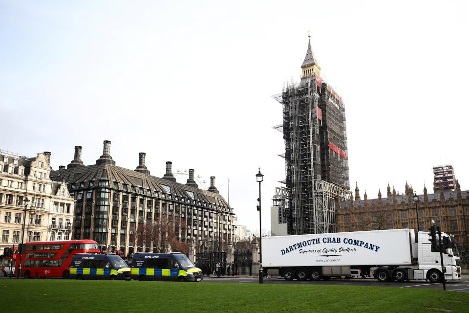 A lorry drives during a protest against post-Brexit bureaucracy that hinders exports to the European Union, as police officers in vans watch over the demonstration at the Parliament Square in London, Britain, January 18, 2021. REUTERS/Hannah McKay