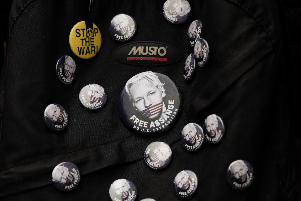 Pins are stuck to a backpack as protesters stand in front of the Ecuadorian Embassy in London, Thursday, April 11, 2024, where Wikileaks founder Julian Assange was arrested five years ago. US President Joe Biden said Wednesday that he is considering a request from Australia to drop the decade-long U.S. push to prosecute Wikileaks founder Julian Assange for publishing a trove of American classified documents.(AP Photo/Frank Augstein)