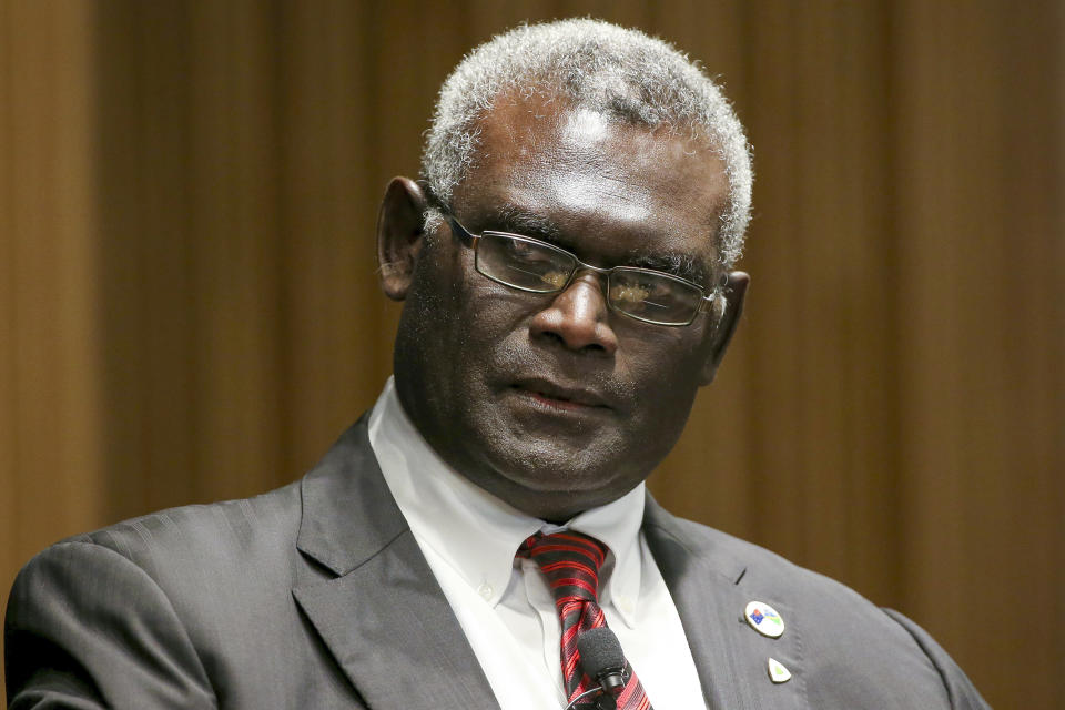 FILE - Manasseh Sogavare, Prime Minister of Solomon Islands attends a Lowy Institute event in Sydney, Monday Aug. 14, 2017. Solomon Islands Prime Minister Sogavare has blamed foreign interference over his government's decision to switch alliances from Taiwan to Beijing for anti-government protests, arson and looting that have ravaged the capital in recent days. (AP Photo/Rick Rycroft, File)