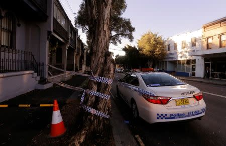 A police car and cordon tape surrounds a property targeted in recent raids related to a planned attack on Australia's aviation sector in the Sydney suburb of Surry Hills, Australia, August 4, 2017. REUTERS/Jason Reed