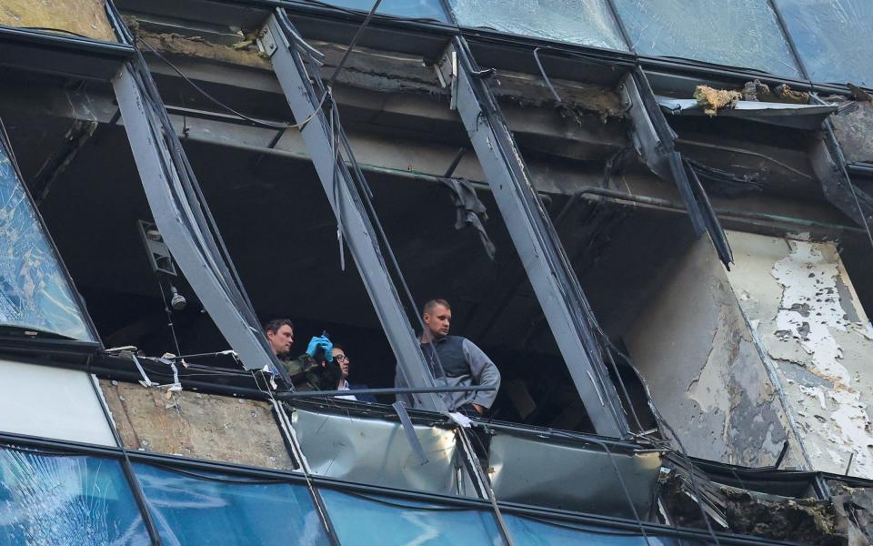 Security services investigate a damaged office building in the Moscow City following a reported Ukrainian drone attack