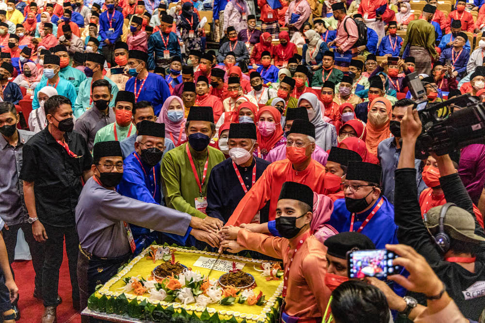 Umno president Datuk Seri Ahmad Zahid Hamidi with other party leaders cut a Malay traditional ‘pulut kuning’ cake in conjunction with Umno’s 76th anniversary at the World Trade Centre in Kuala Lumpur May 15, 2022. — Picture by Firdaus Latif