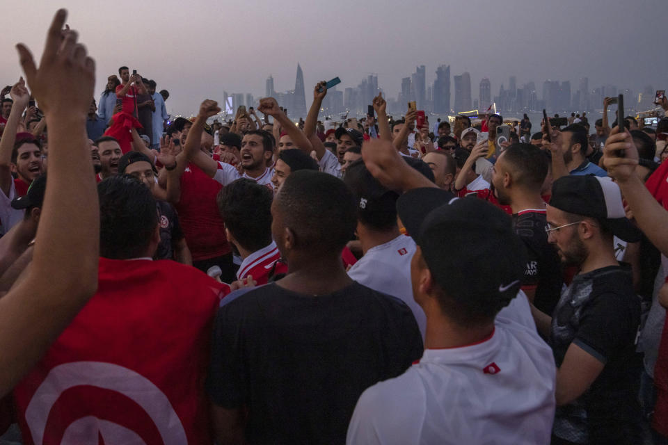 Tunisians gather to celebrate and represent their community in front of the official FIFA World Cup Countdown Clock on Doha's corniche, only 30 days away from the event, in Qatar, Friday, Oct. 21, 2022. (AP Photo/Nariman El-Mofty)