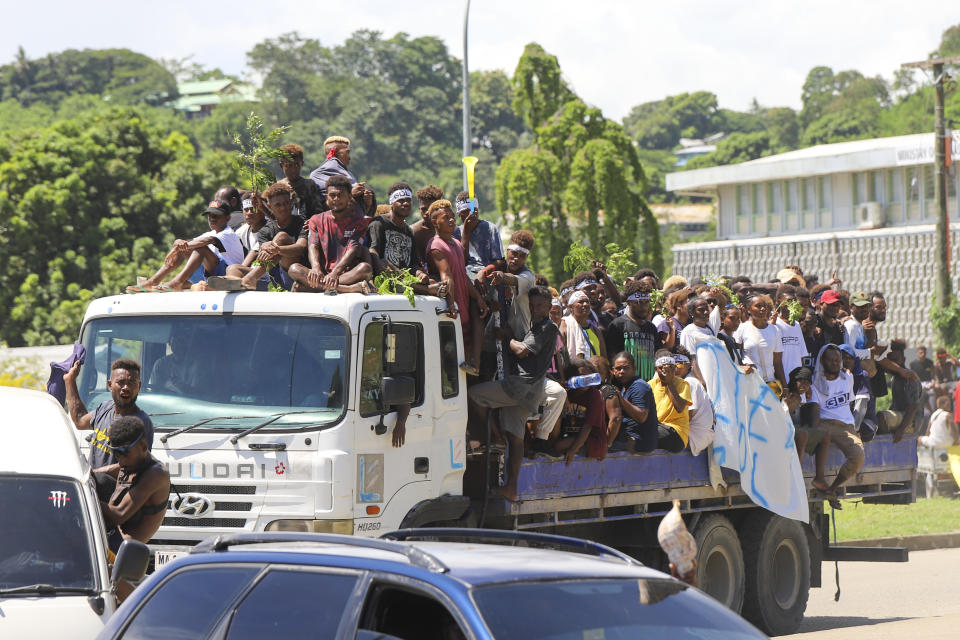 Locals react as they participate in a candidates parade in the capital Honiara, Solomon Islands, Monday, April 15, 2024. The country in which China has gained most influence in the South Pacific, Solomon Islands, goes to the polls on Wednesday in an election that could shape the region's future. (AP Photo/Charley Priringi)