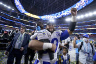 Los Angeles Rams defensive end Aaron Donald carries his son Aric while celebrating after the Rams defeated the Cincinnati Bengals in the NFL Super Bowl 56 football game Sunday, Feb. 13, 2022, in Inglewood, Calif. (AP Photo/Marcio Jose Sanchez)