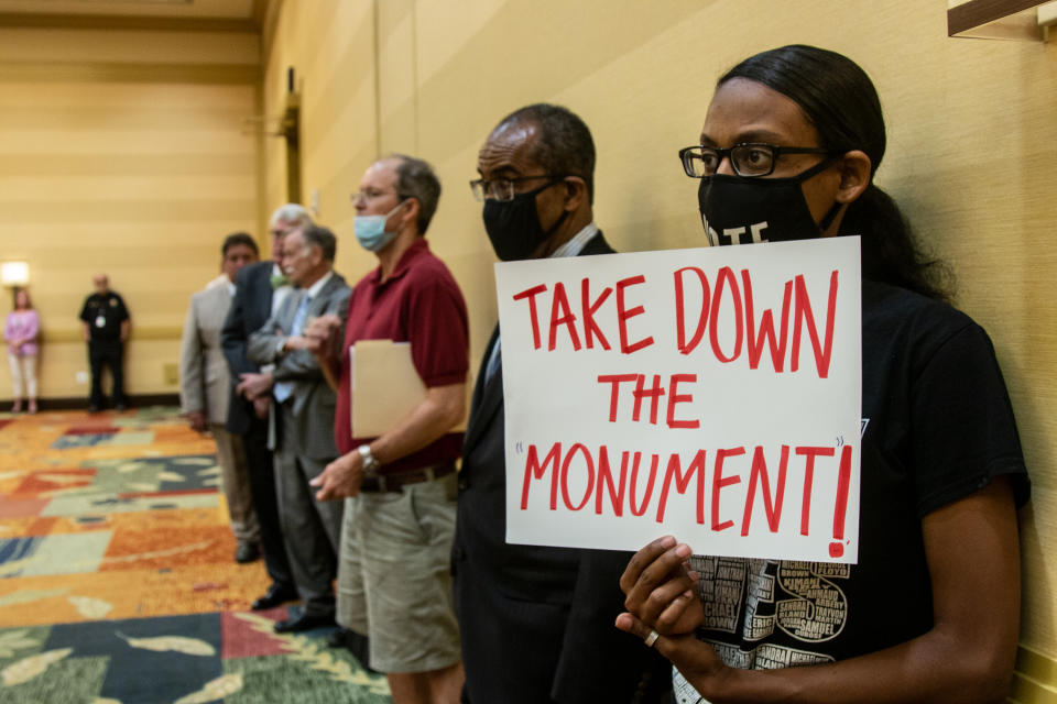 People attend a meeting of the Stone Mountain Memorial Association Monday, May 24, 2021, in Stone Mountain, Ga. The Stone Mountain Memorial Association board approved some minor changes in the popular Confederate-themed park, located near Atlanta, but did not address any possible changes to the carving or streets named after Confederate generals as some had hoped. (AP Photo/Ron Harris)