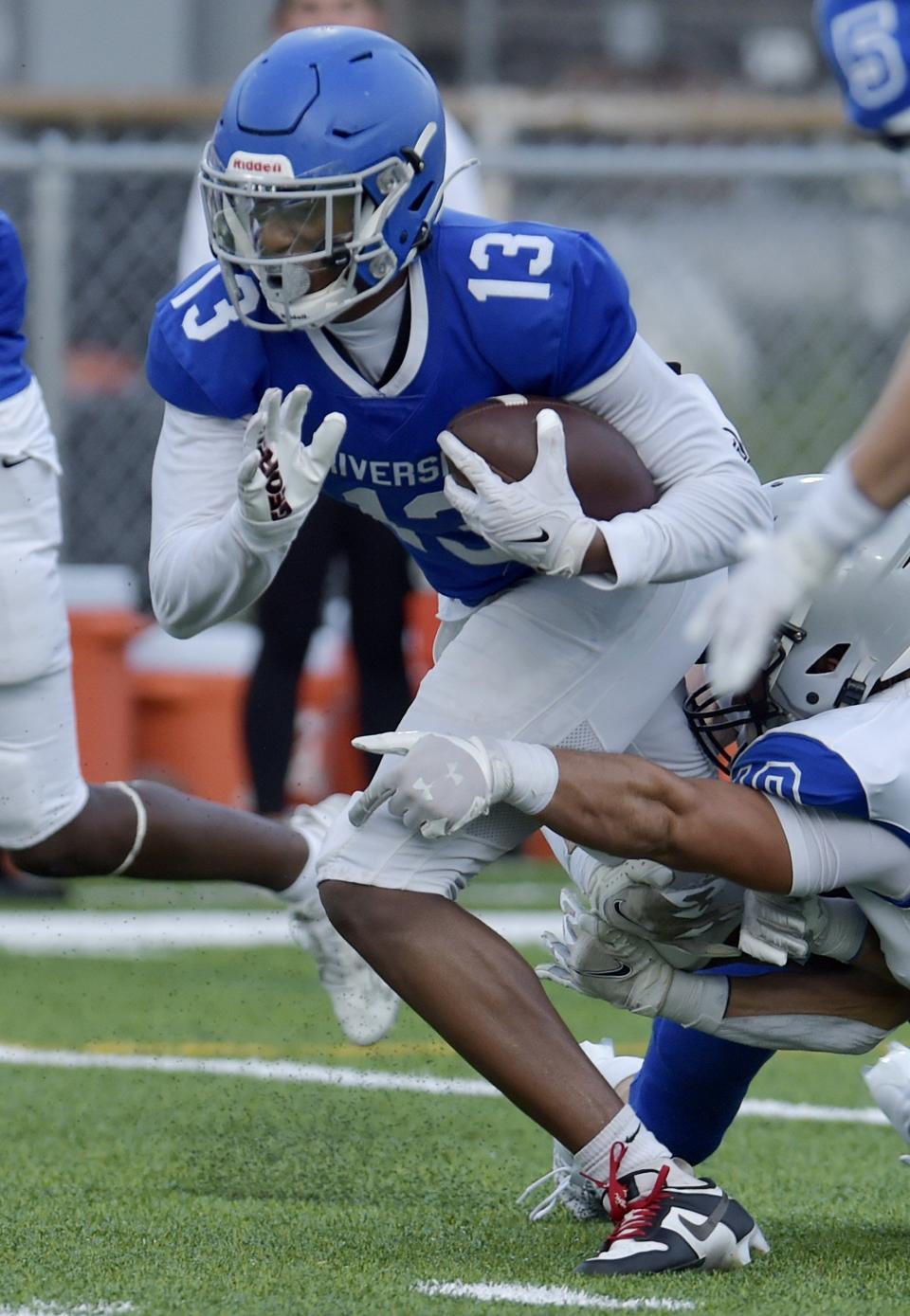 Riverside's Tae'shaun Gelsey runs for yardage against Bartram Trail.