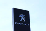 The logo of French car maker maker Peugeot is seen outside a technical center Tuesday, May 26, 2020 in Villacoublay, west of Paris. French President Emmanuel Macron is set to unveil on Tuesday new measures to rescue the country's car industry, which has been hammered by the virus lockdown and the resulting recession. The issue is politically sensitive, since France is proud of its auto industry, which employs 400,000 people in the country and is a big part of its manufacturing sector. (AP Photo/Michel Euler)