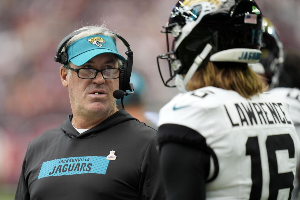 Jacksonville Jaguars head coach Doug Pederson talks with quarterback Trevor Lawrence (16) during the first half of an NFL football game against the Houston Texans, Sunday, Sept. 29, 2024, in Houston. (AP Photo/Eric Gay)