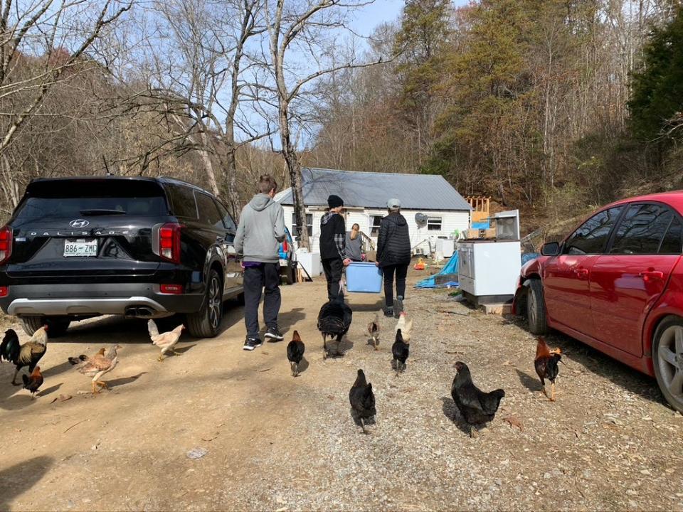 Saint Matthews School eighth grade students carry supplies to a home in Sneedville, Tenn. as part a middle school ministry program mission trip.