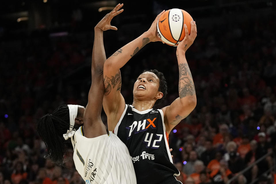 Phoenix Mercury center Brittney Griner (42) gets fouled by Chicago Sky forward Elizabeth Williams (1) during the first half of a WNBA basketball game, Sunday, May 21, 2023, in Phoenix. (AP Photo/Ross D. Franklin)