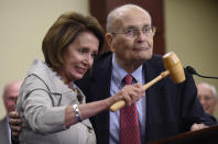 FILE - In this July 29, 2015 file photo, House Minority Leader Nancy Pelosi of Calif., standing with former Rep. John Dingell, D-Mich., holds up the gavel Dingell used 50 years ago when Medicare legislation was passed during an event marking the 50th Anniversary of Medicare and Medicaid on Capitol Hill in Washington. Dingell, the longest-serving member of Congress in American history who mastered legislative deal-making and was fiercely protective of Detroit's auto industry, has died at age 92. Dingell, who served in the U.S. House for 59 years before retiring in 2014, died Thursday, Feb. 7, 2019, at his home in Dearborn, said his wife, Congresswoman Debbie Dingell. (AP Photo/Susan Walsh, File)