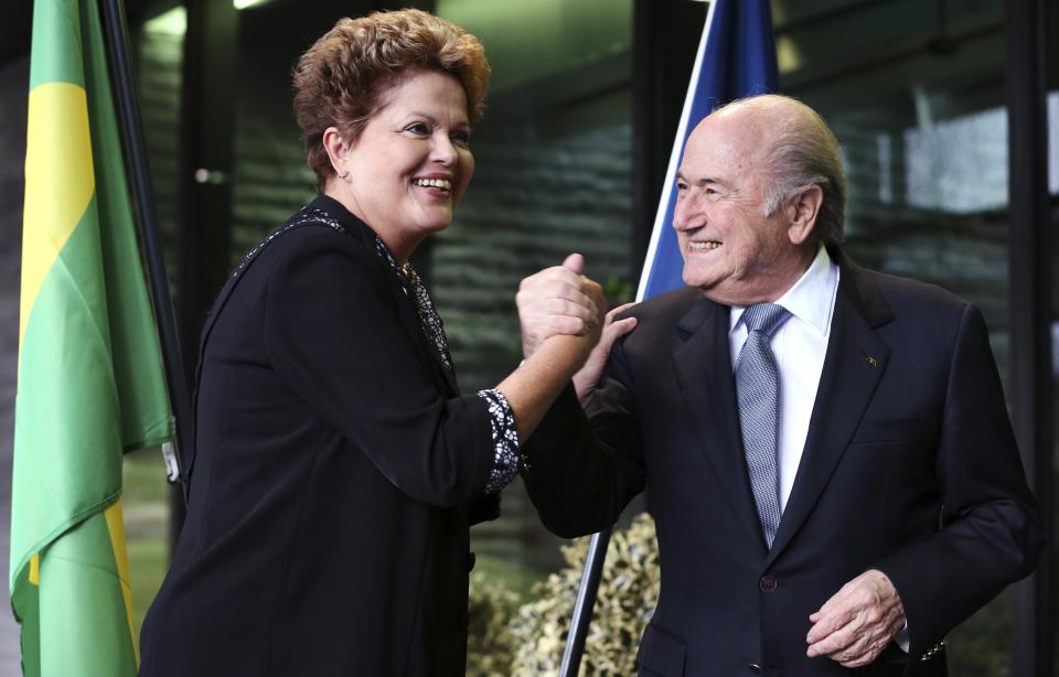 Brazil's President Dilma Rousseff (L) greets FIFA President Sepp Blatter during a visit at the FIFA headquarters in Zurich January 23, 2014. The 2014 World Cup final tournament will be held in Brazil from June 12 through July 13. REUTERS/Thomas Hodel (SWITZERLAND - Tags: SPORT SOCCER WORLD CUP POLITICS)