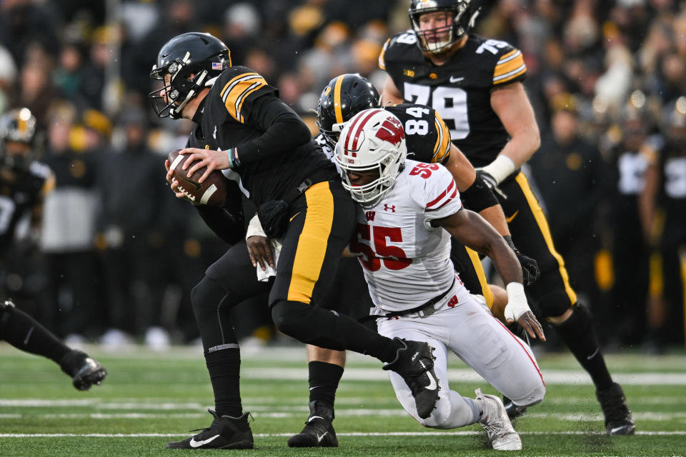 Nov 12, 2022; Iowa City, Iowa, USA; Wisconsin Badgers linebacker Maema Njongmeta (55) sacks Iowa Hawkeyes quarterback <a class="link " href="https://sports.yahoo.com/ncaaf/players/287441" data-i13n="sec:content-canvas;subsec:anchor_text;elm:context_link" data-ylk="slk:Spencer Petras;sec:content-canvas;subsec:anchor_text;elm:context_link;itc:0">Spencer Petras</a> (7) during the second quarter at Kinnick Stadium. Mandatory Credit: Jeffrey Becker-USA TODAY Sports