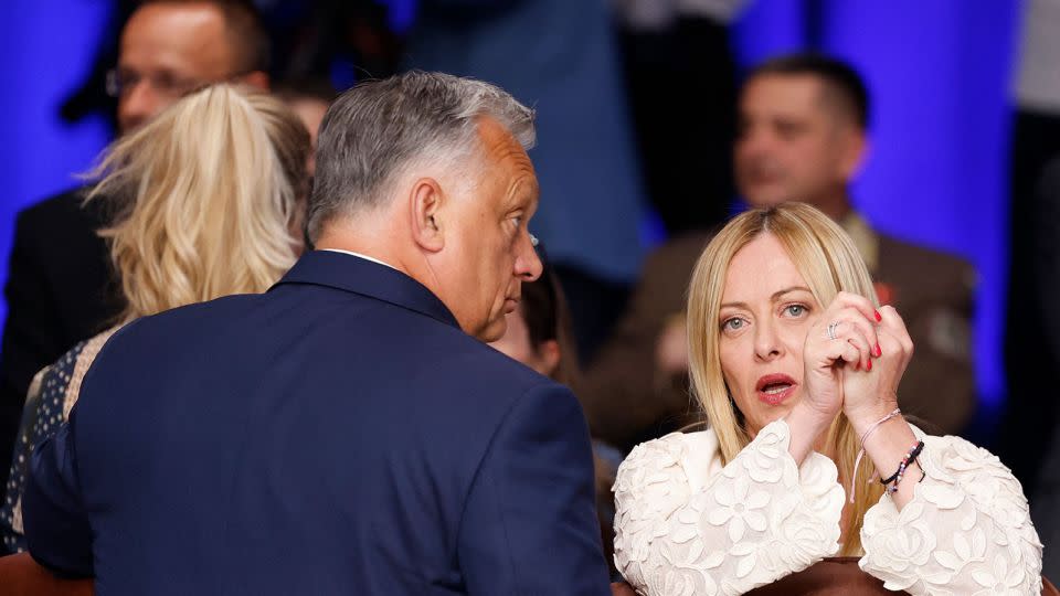 Italy's Prime Minister Giorgia Meloni speaks with her Hungarian counterpart Viktor Orban at the NATO summit in Vilnius on July 12, 2023. - Odd Andersen/AFP/Getty Images