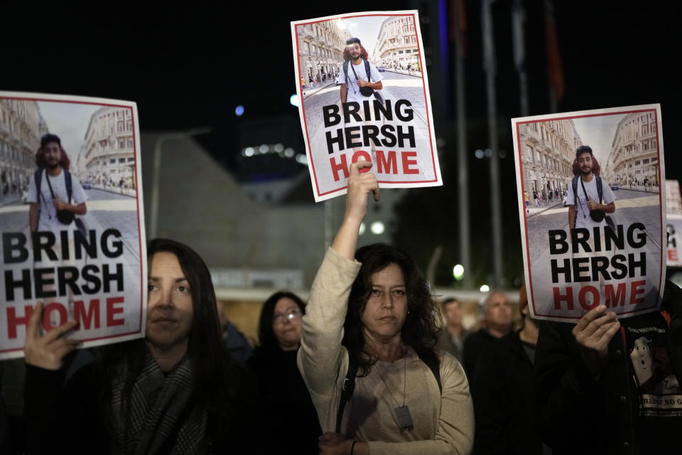 People hold signs showing a picture of a hostage during a demonstration calling for the release of the hostages taken by Hamas militants to Gaza during the Oct. 7th attack, during a demonstration in Tel Aviv, Israel, Saturday Jan. 20, 2024. (AP Photo/Leo Correa)
