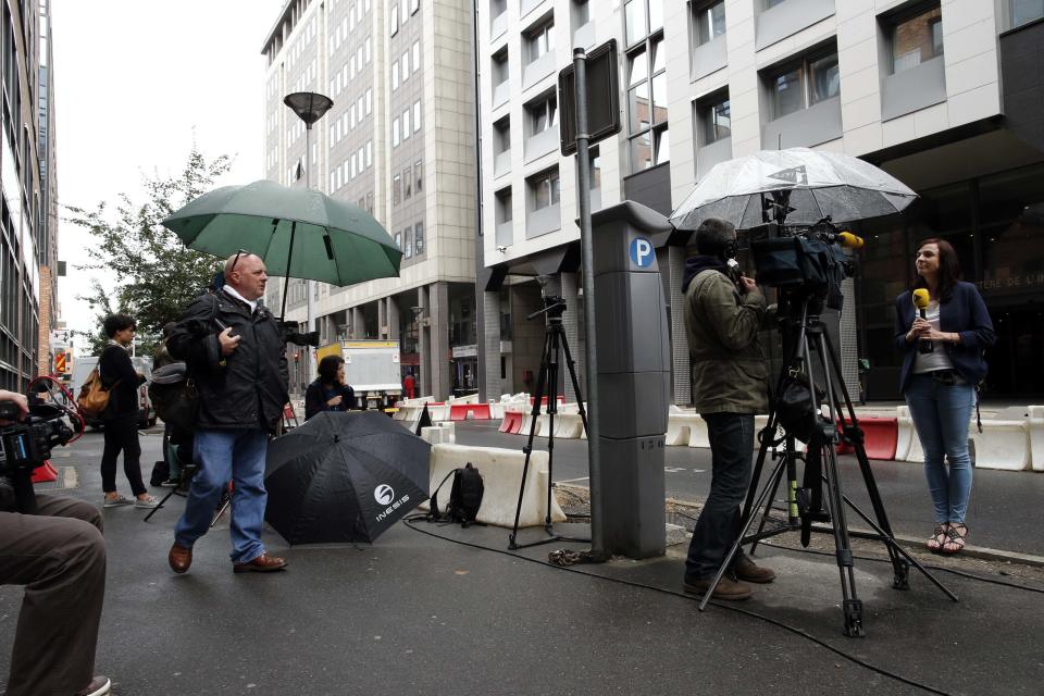 Journalists stand in front of the offices of the judicial police in Nanterre, near Paris, July 1, 2014, where former French President Nicolas Sarkozy arrived early Tuesday to be quizzed by investigators. Former French President Sarkozy was held on Tuesday for questioning into suspicions that a network of informers kept him abreast of a separate inquiry into alleged irregularities in his 2007 election campaign, a legal source said. Local media said it was the first time a former head of state had been held for questioning in modern French history. REUTERS/Benoit Tessier (FRANCE - Tags: POLITICS CRIME LAW MEDIA)