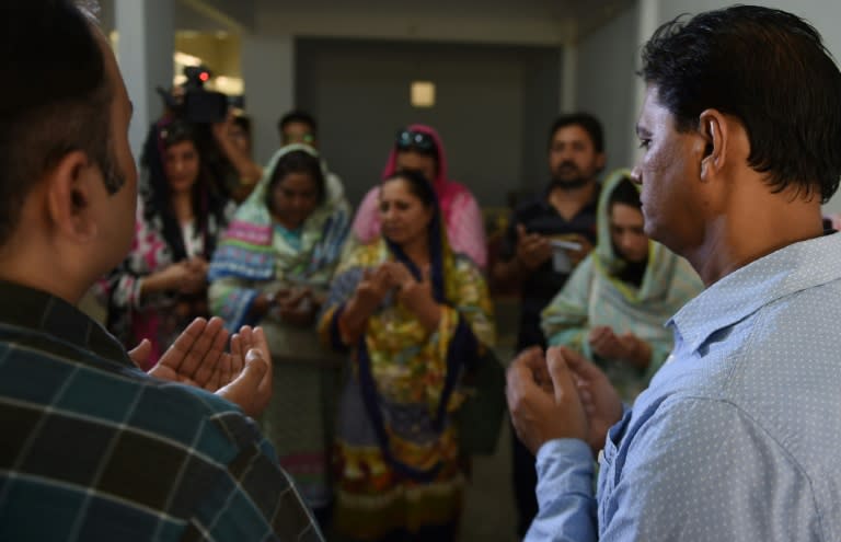 Abdul Aziz (R, with mourners) learned about the death of his daughter Sabika Sheikh while watching the news on TV