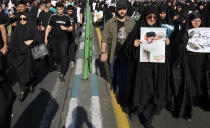 Iranians attend a funeral ceremony for the late President Ebrahim Raisi and his companions who were killed in a helicopter crash on Sunday in a mountainous region of the country's northwest, in Tehran, Iran, Wednesday, May 22, 2024. Iran's supreme leader presided over the funeral Wednesday for the country's late president, foreign minister and others killed in the helicopter crash, as tens of thousands later followed a procession of their caskets through the capital, Tehran. (AP Photo/Vahid Salemi)